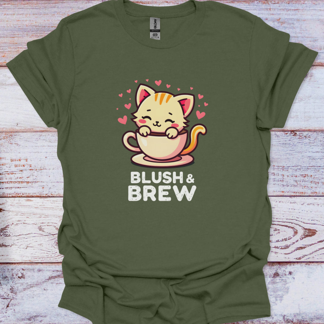 Green t-shirt with a cat holding a coffee cup design and 'Blush & Brew' text on a wooden surface.