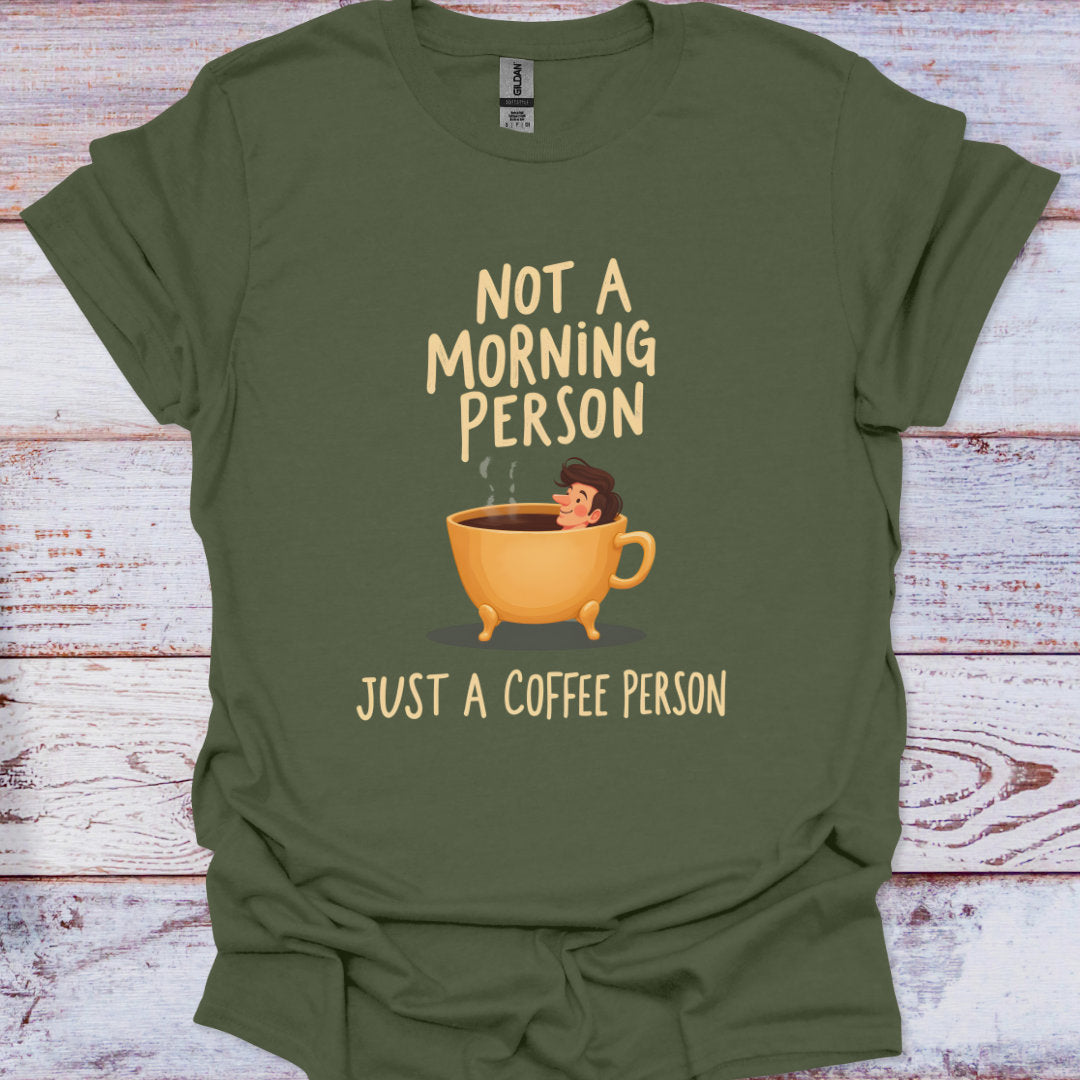Green t-shirt with a coffee cup graphic and text on a wooden surface