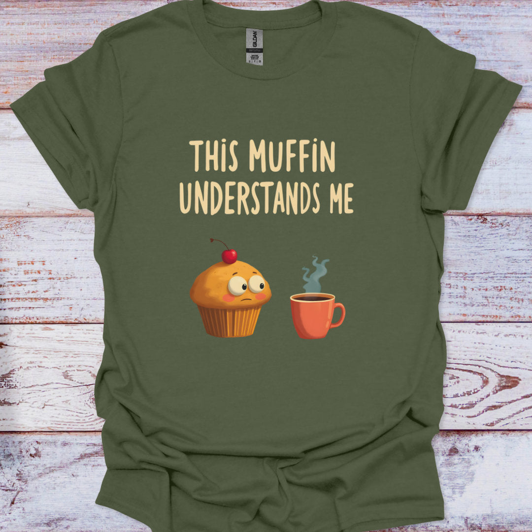 Green t-shirt with a graphic of a muffin and coffee cup and text 'This Muffin Understands Me' on a wooden surface.