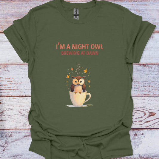 Green t-shirt with an owl graphic and text on a wooden surface