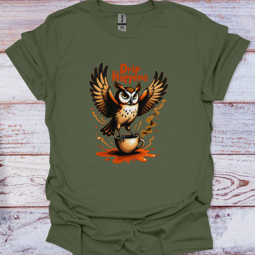Green t-shirt with an owl holding a coffee cup and 'Drip Happens' text on a wooden surface