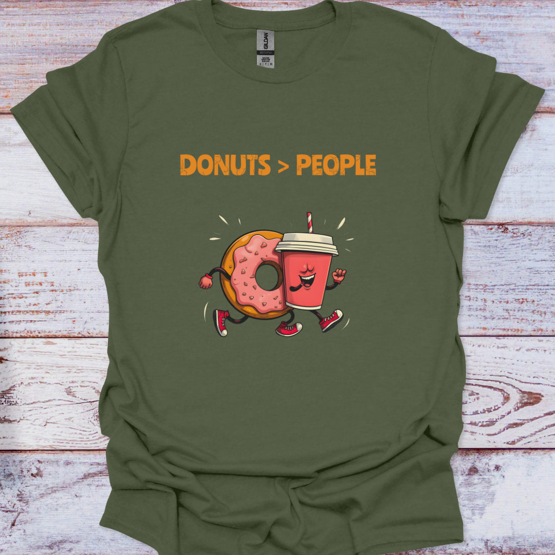 Green t-shirt with cartoon donut and coffee cup design and 'DONUTS > PEOPLE' text on a wooden surface.