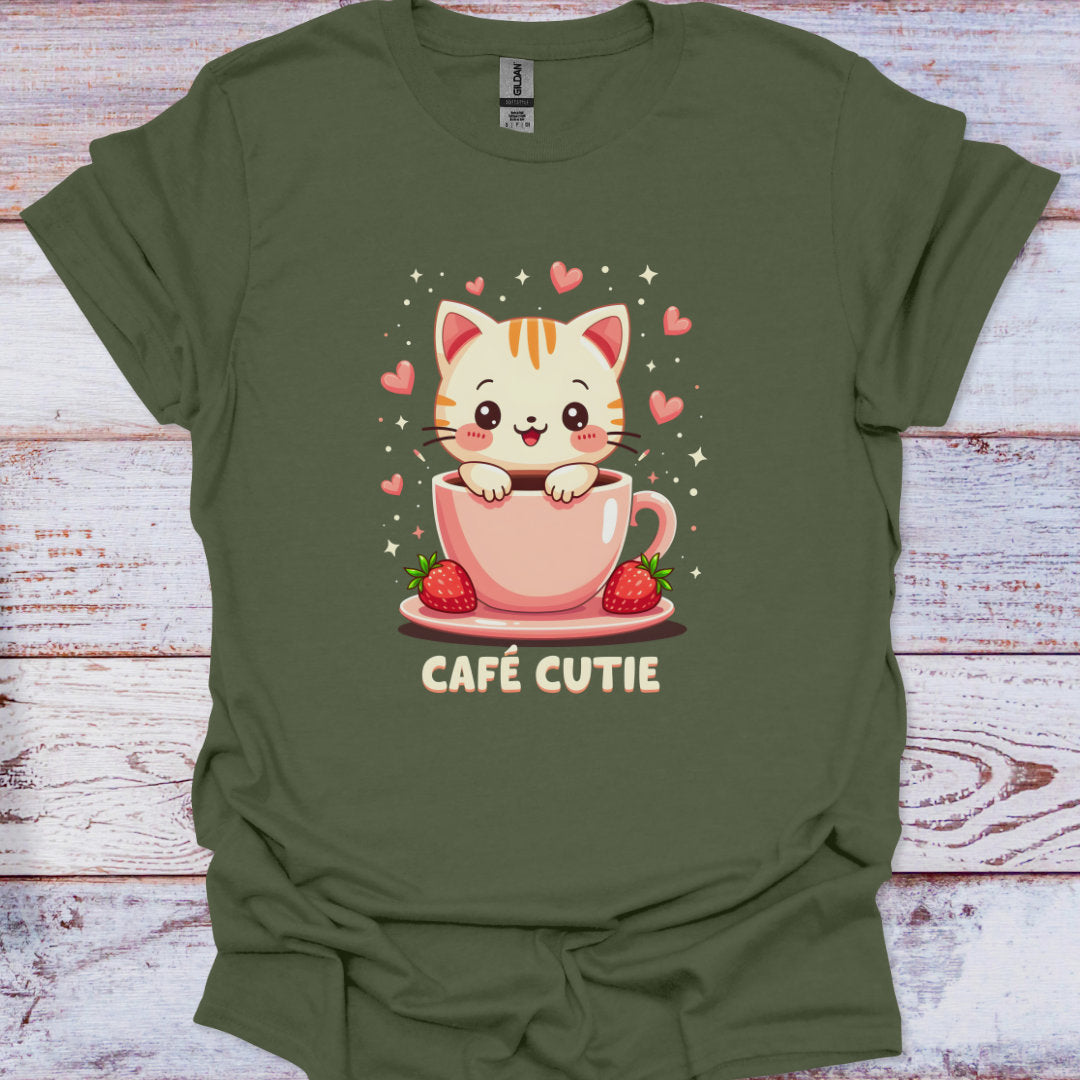 Green t-shirt with a cute cat design in a pink cup on a wooden surface