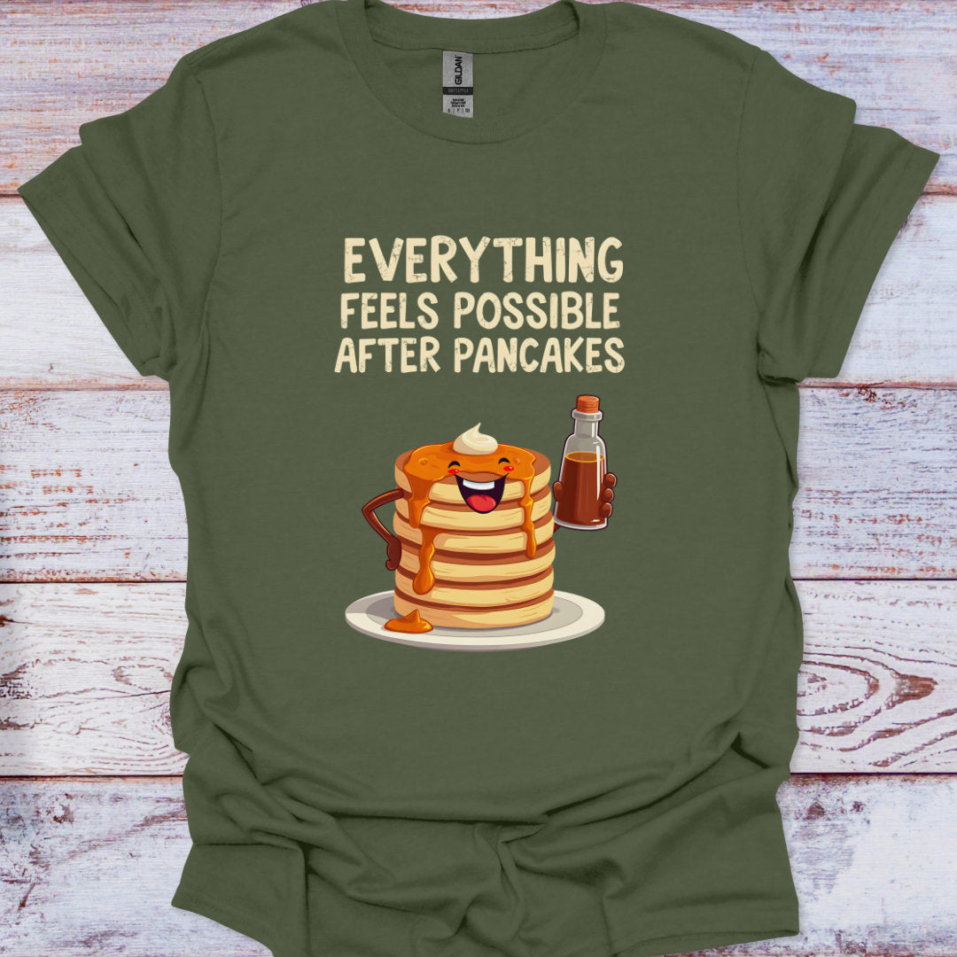 Green t-shirt with cartoon pancakes and syrup bottle on a wooden surface