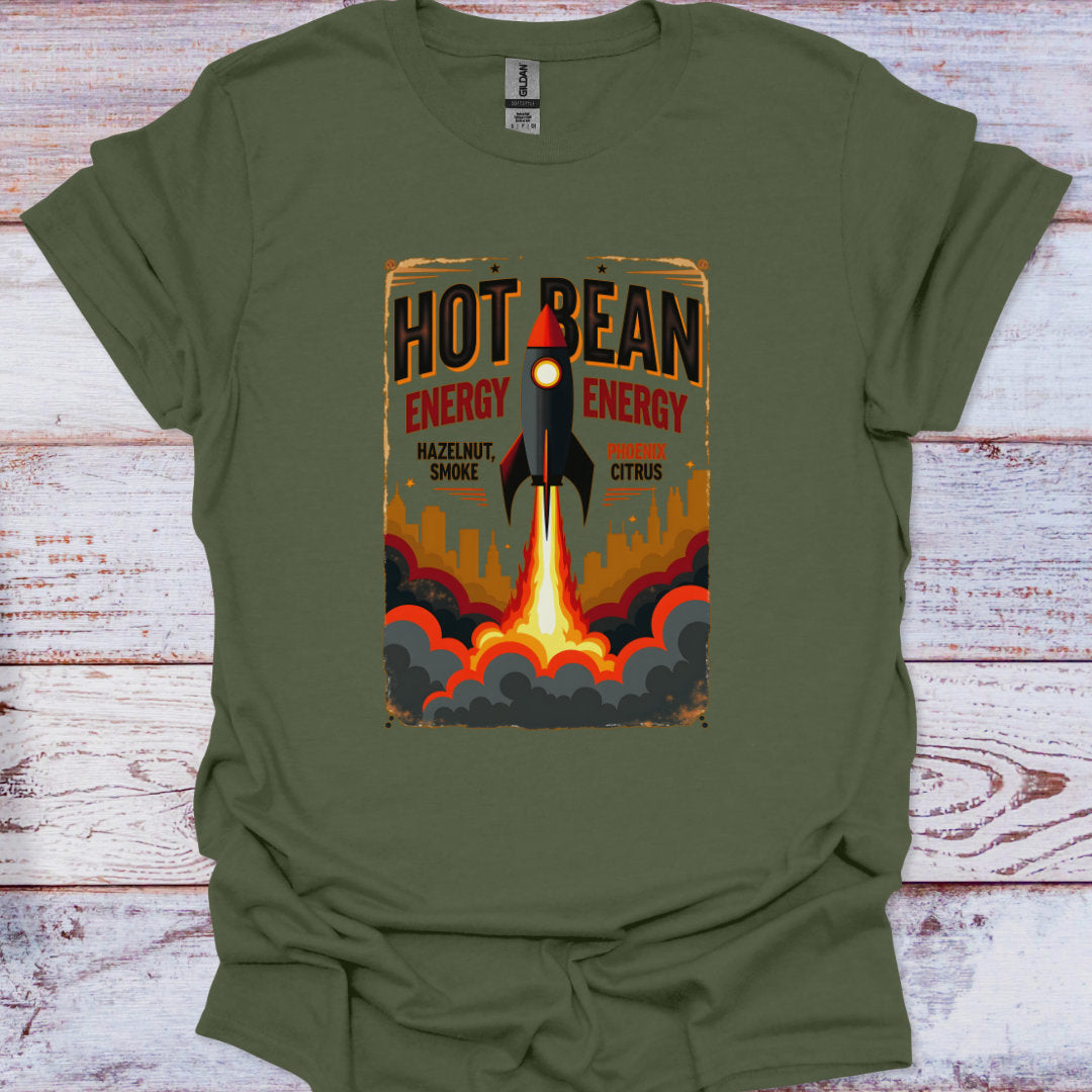 Green t-shirt with a graphic design of a rocket and 'Hot Bean Energy' text on a wooden surface.