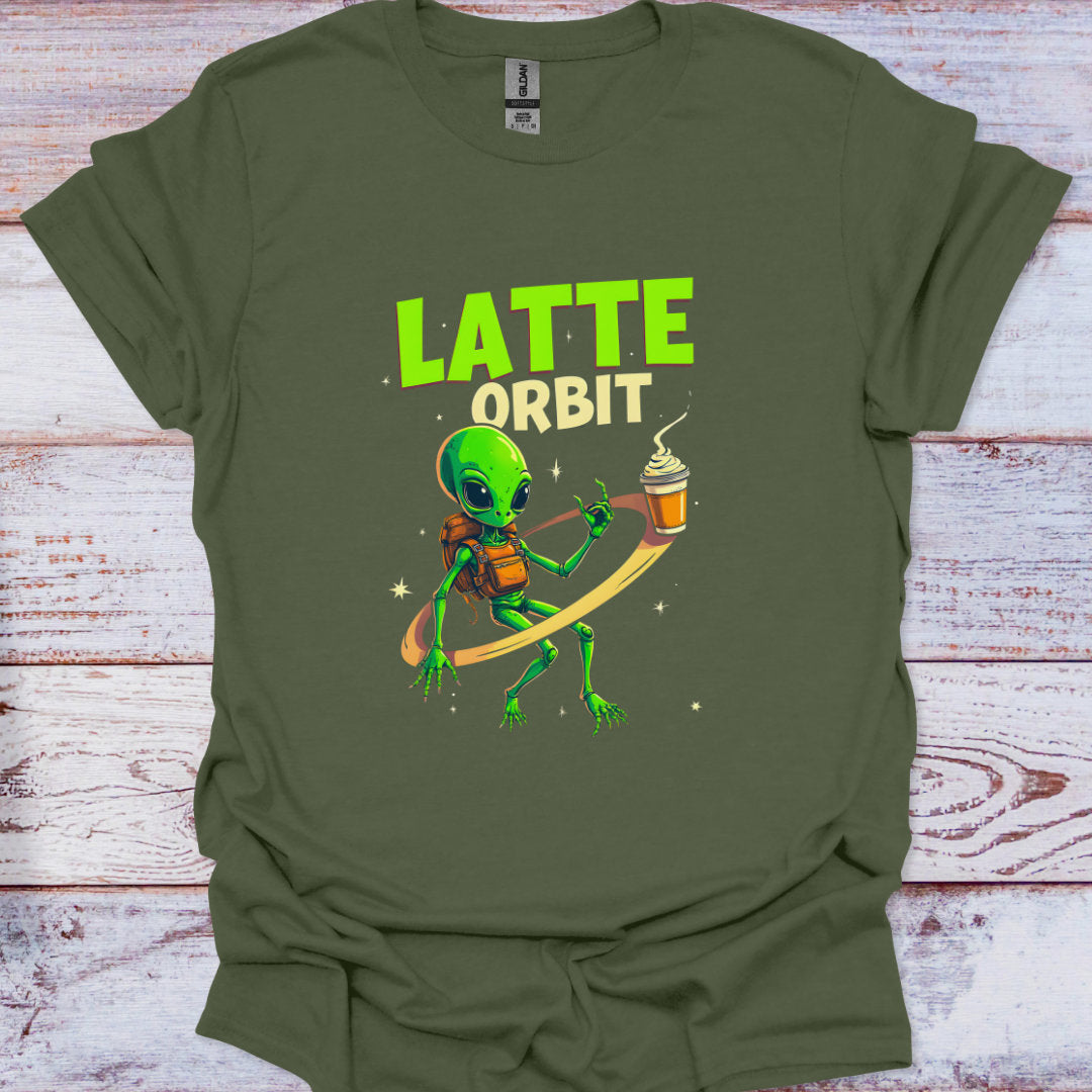 Green t-shirt with an alien holding a coffee cup and 'Latte Orbit' text on a wooden surface