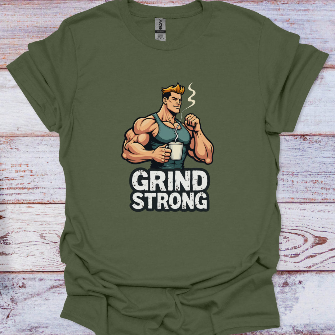 Green t-shirt with a graphic of a muscular man holding a coffee cup and 'Grind Strong' text on a wooden surface.