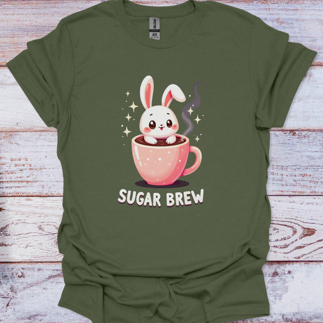 Green t-shirt with a cartoon bunny in a pink cup and 'Sugar Brew' text on a wooden surface
