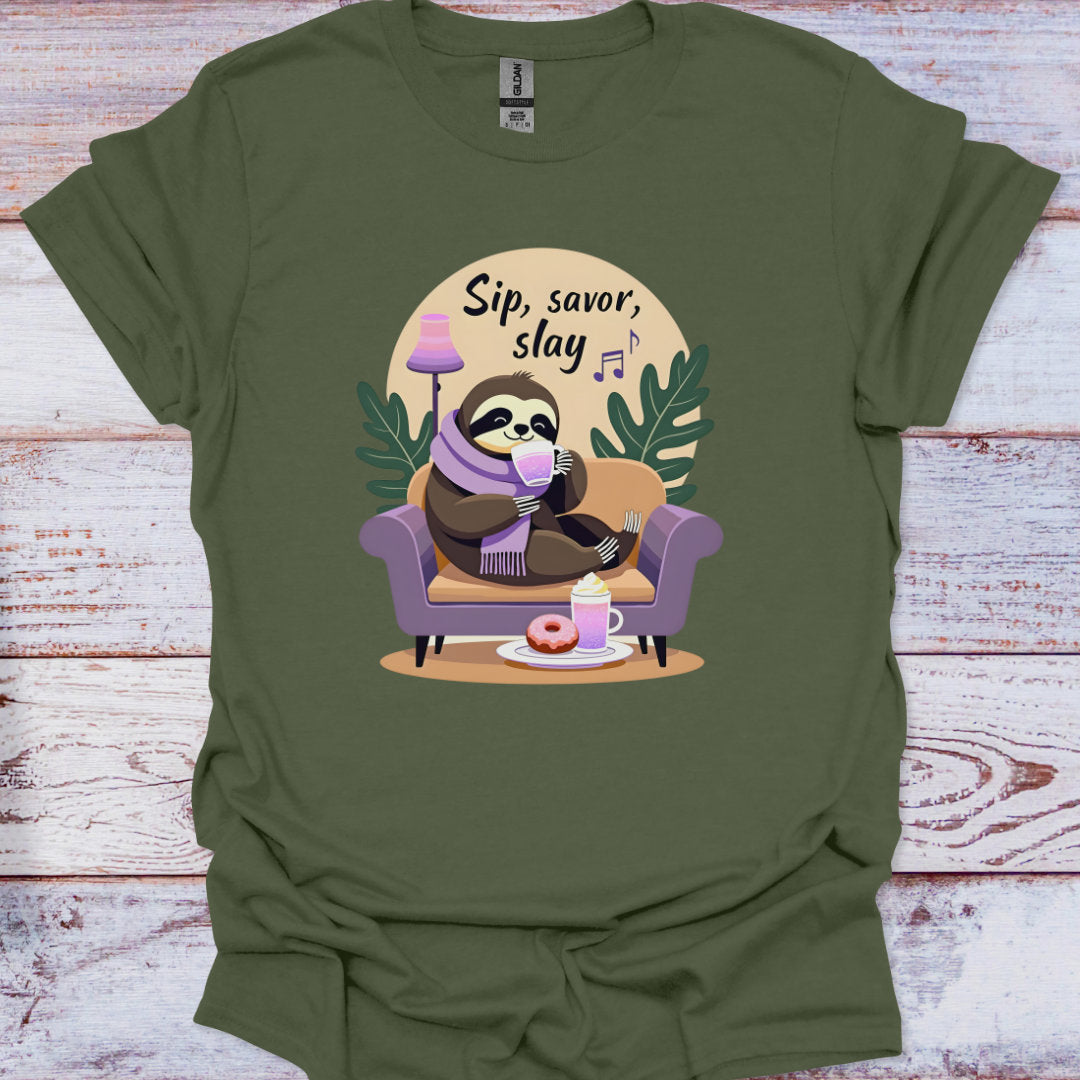 Green t-shirt with a sloth graphic and 'Sip, savor, slay' text on a wooden surface