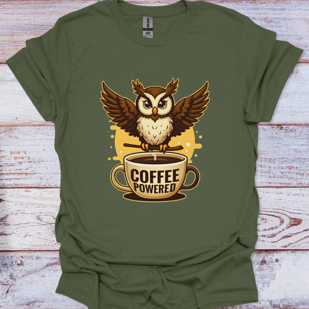 Green t-shirt with an owl and 'Coffee Powered' design on a wooden surface