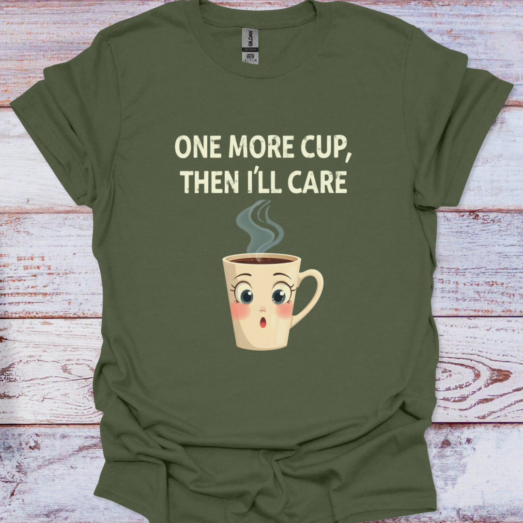 Green t-shirt with a cartoon coffee cup and text on a wooden surface