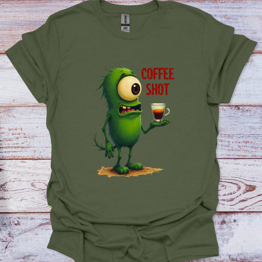 Green t-shirt with a cartoon character holding a coffee shot and 'COFFEE SHOT' text on a wooden surface.