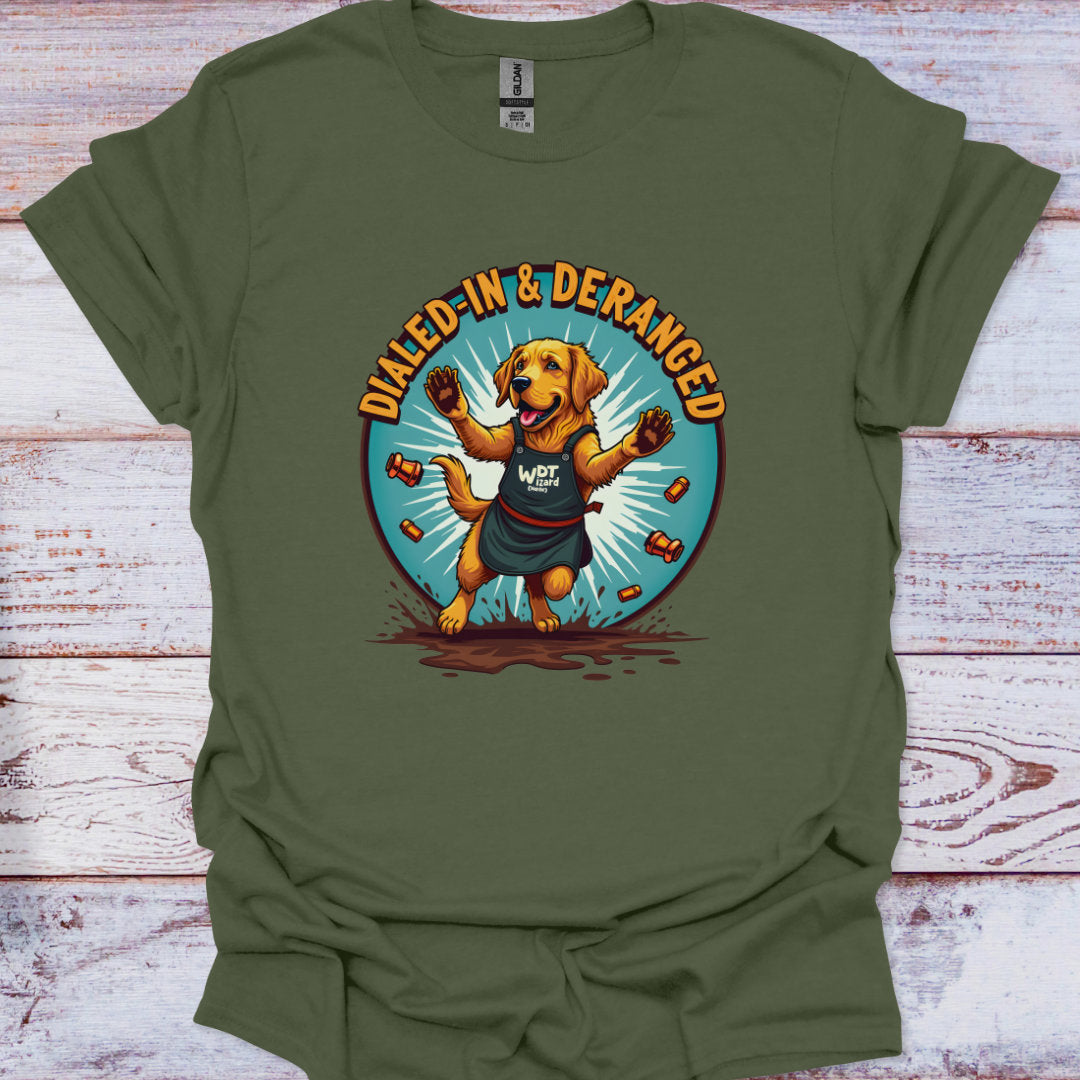 Green t-shirt with a dog graphic and 'Dialed-In & Deranged' text on a wooden surface