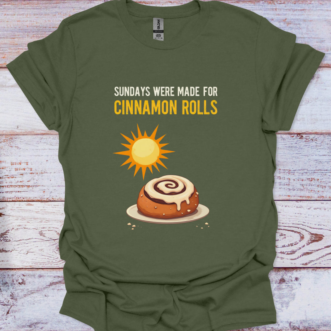 Green t-shirt with a cinnamon roll graphic and text on a wooden surface