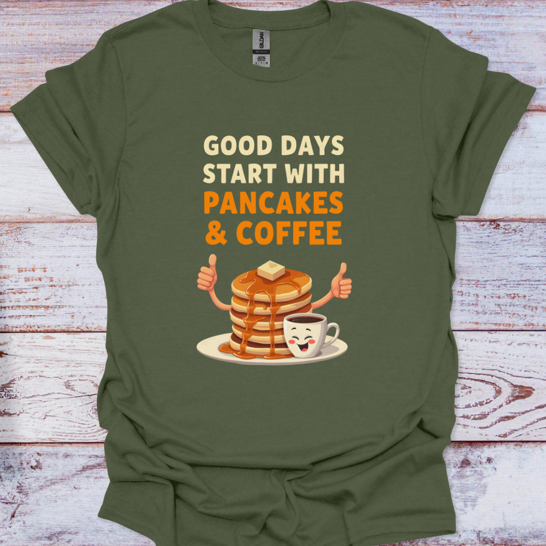 Green t-shirt with 'Good days start with pancakes & coffee' text and cartoon design on a wooden surface