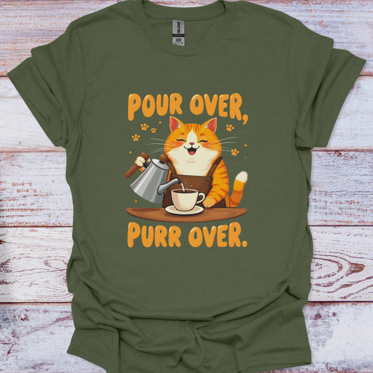 Green t-shirt with a cat pouring coffee design and text 'Pour Over, Purr Over' on a wooden surface.