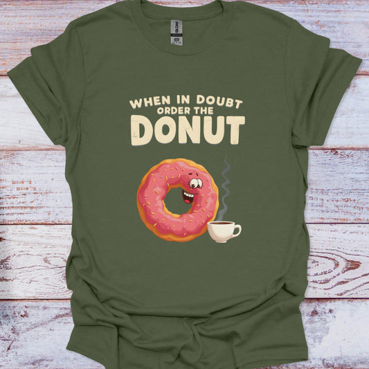 Green t-shirt with a donut graphic and text on a wooden surface
