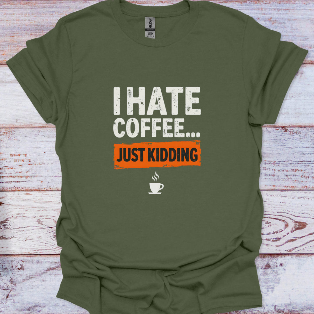 Green t-shirt with 'I HATE COFFEE... JUST KIDDING' text on a wooden surface
