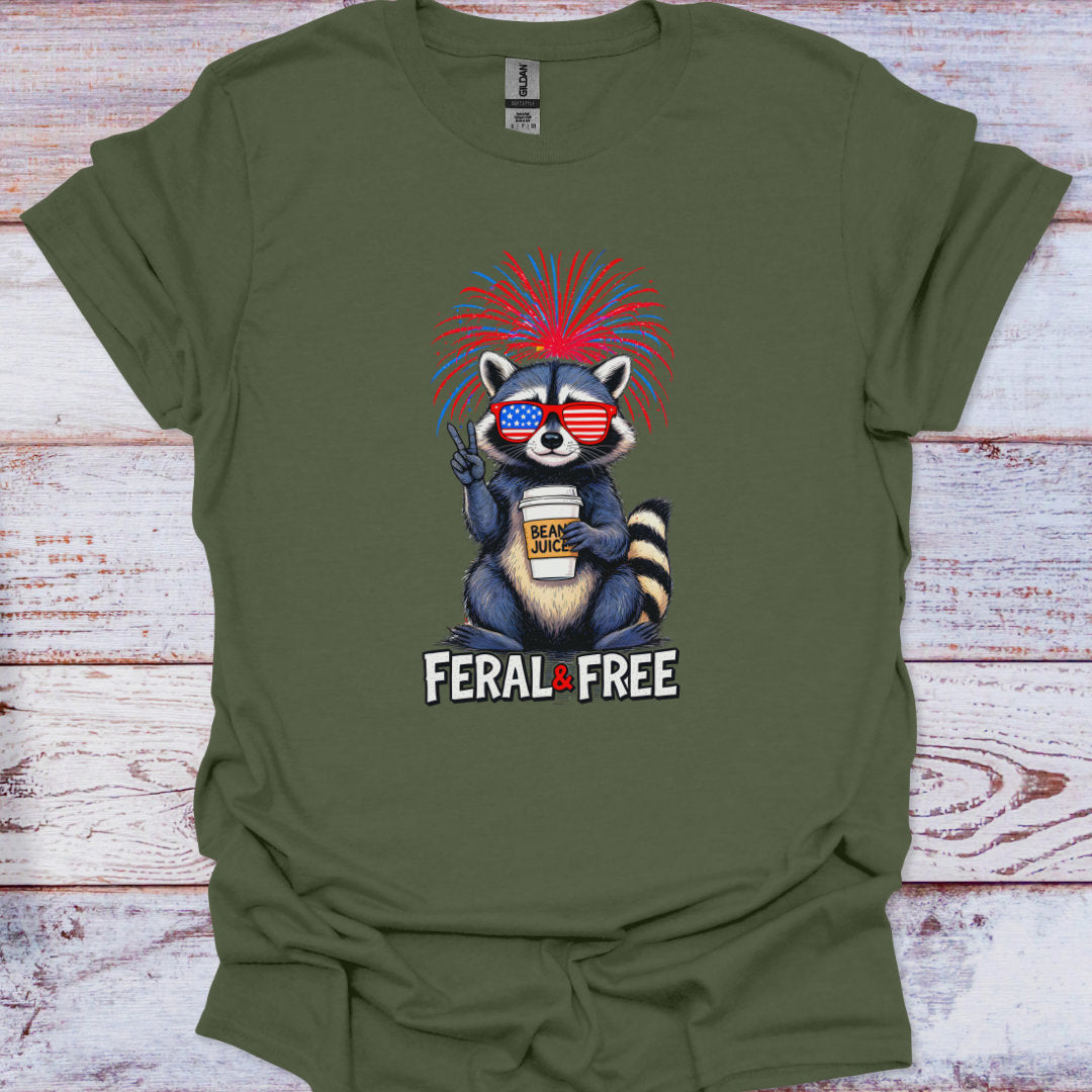 Green t-shirt with a raccoon graphic and 'Feral & Free' text on a wooden surface