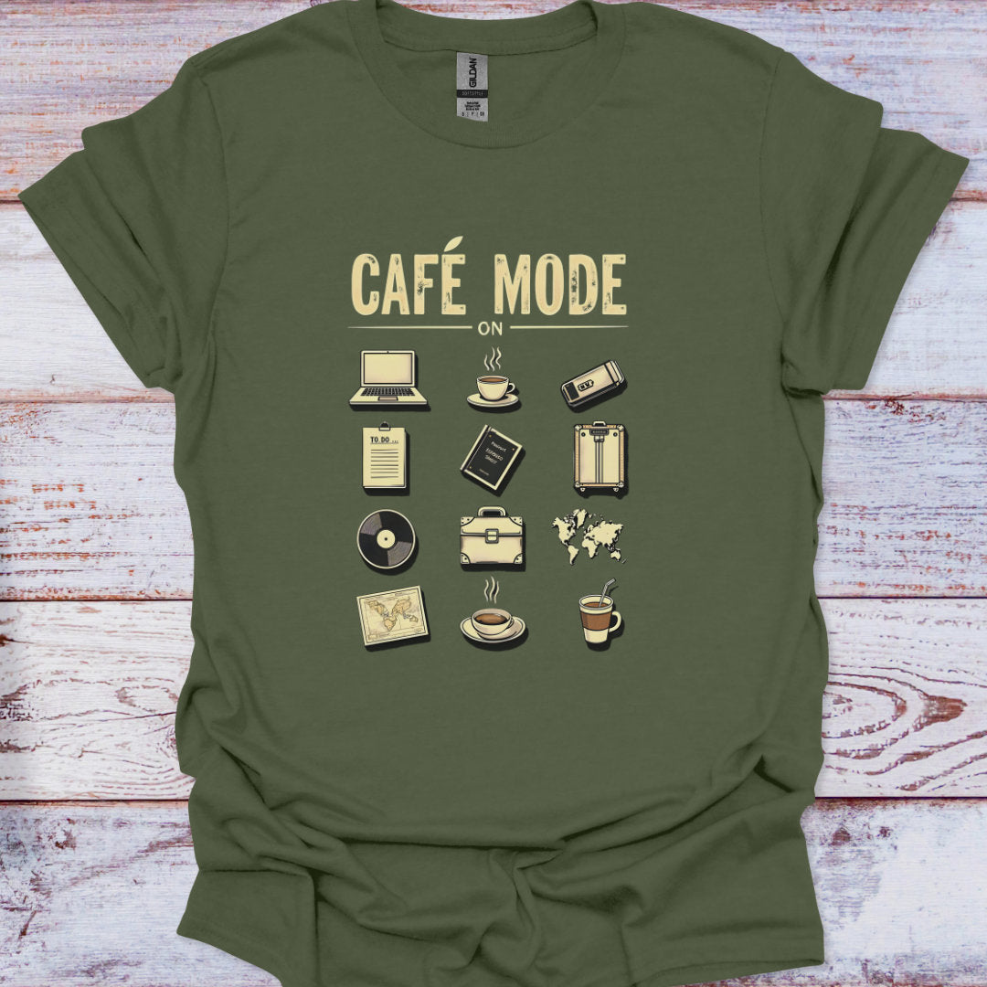 Green t-shirt with 'Café Mode' graphic design on a wooden surface
