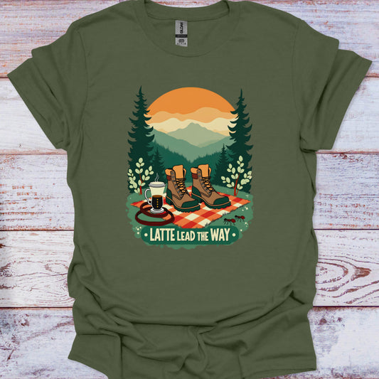 Green t-shirt with a graphic of hiking boots, coffee, and trees on a wooden surface