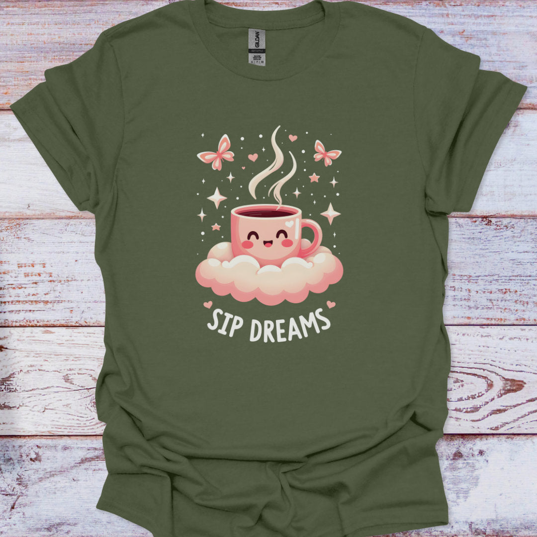 Green t-shirt with a cartoon coffee cup design and 'Sip Dreams' text on a wooden surface.