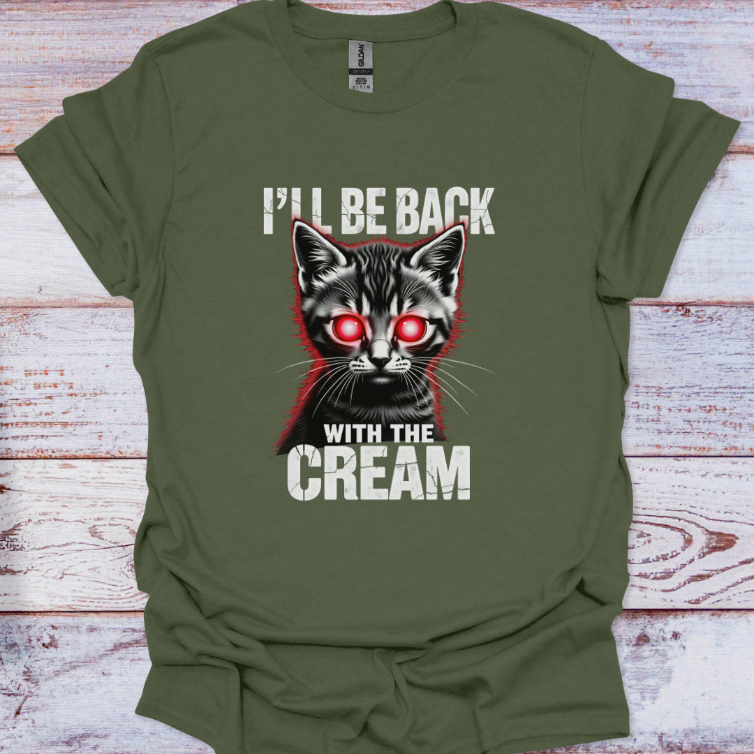 Green t-shirt with a graphic of a cat and text 'I'll be back with the cream' on a wooden surface.