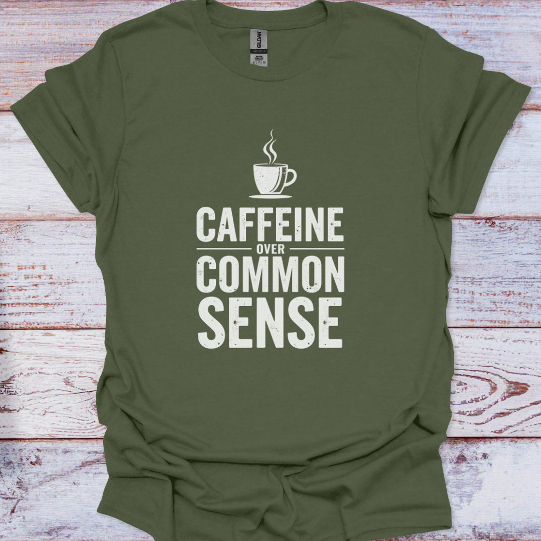 Green t-shirt with 'CAFFEINE OVER COMMON SENSE' text and coffee cup graphic on a wooden surface