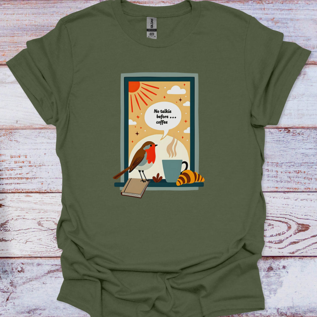Green t-shirt with a graphic design of a bird, coffee cup, and book on a wooden surface