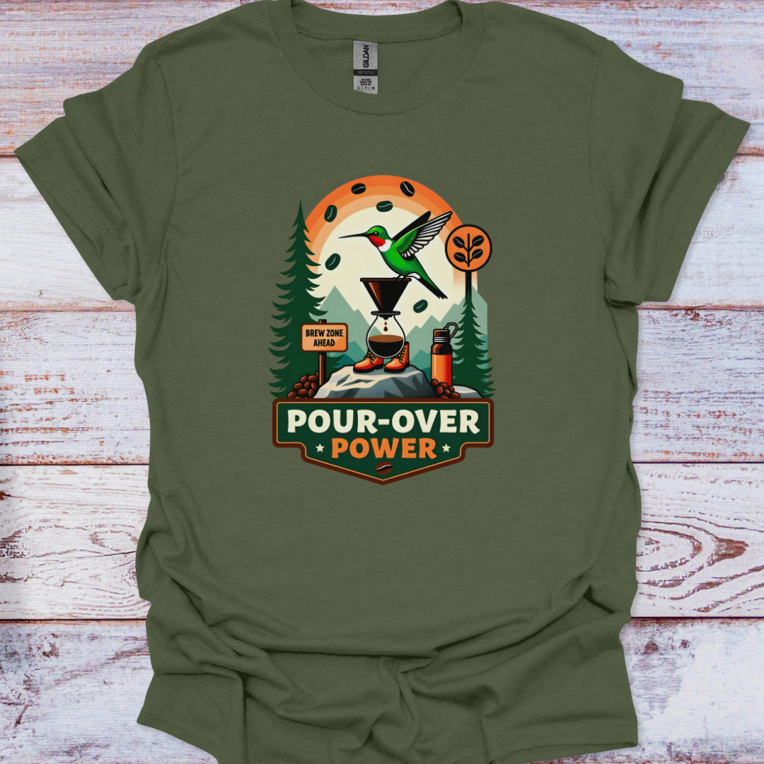Green t-shirt with a graphic design featuring a hummingbird, trees, and text on a wooden surface.