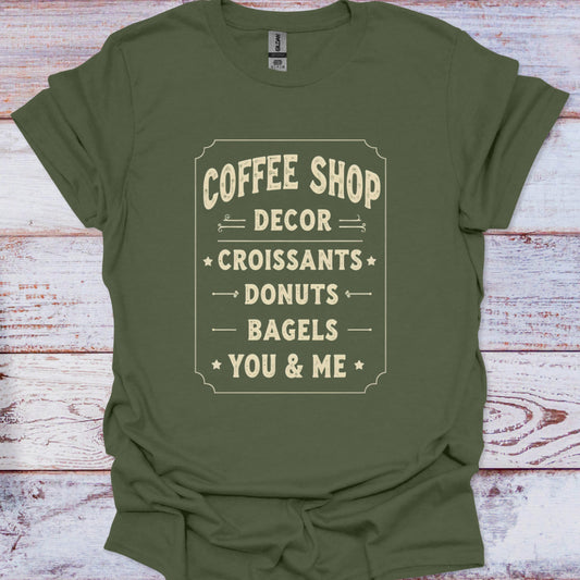 Green t-shirt with text design on a wooden surface
