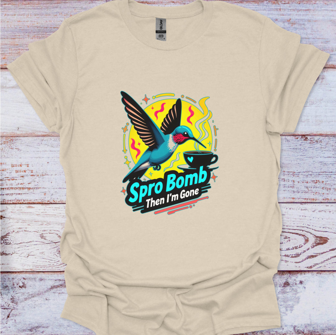 Beige t-shirt with a colorful graphic of a hummingbird and text on a wooden surface