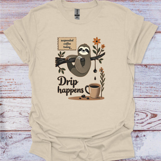 Beige t-shirt with a sloth and coffee graphic on a wooden surface
