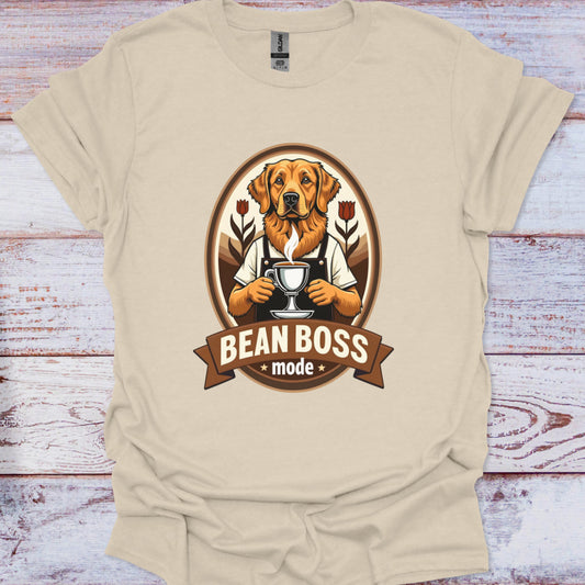 Beige t-shirt with a dog graphic and 'Bean Boss' text on a wooden surface
