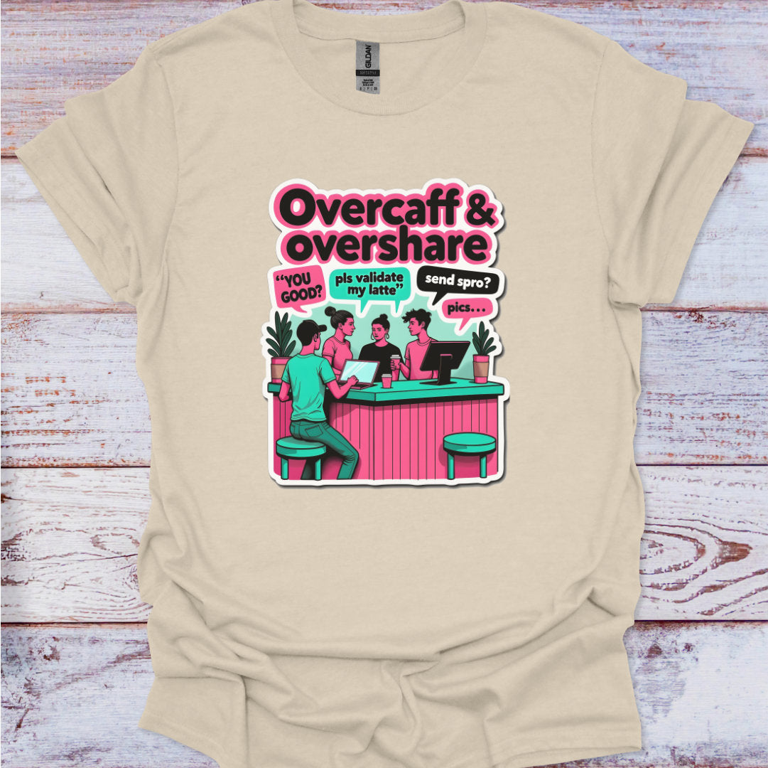 Beige t-shirt with a graphic design featuring people at a bar and text 'Overcaff & overshare' on a wooden surface.