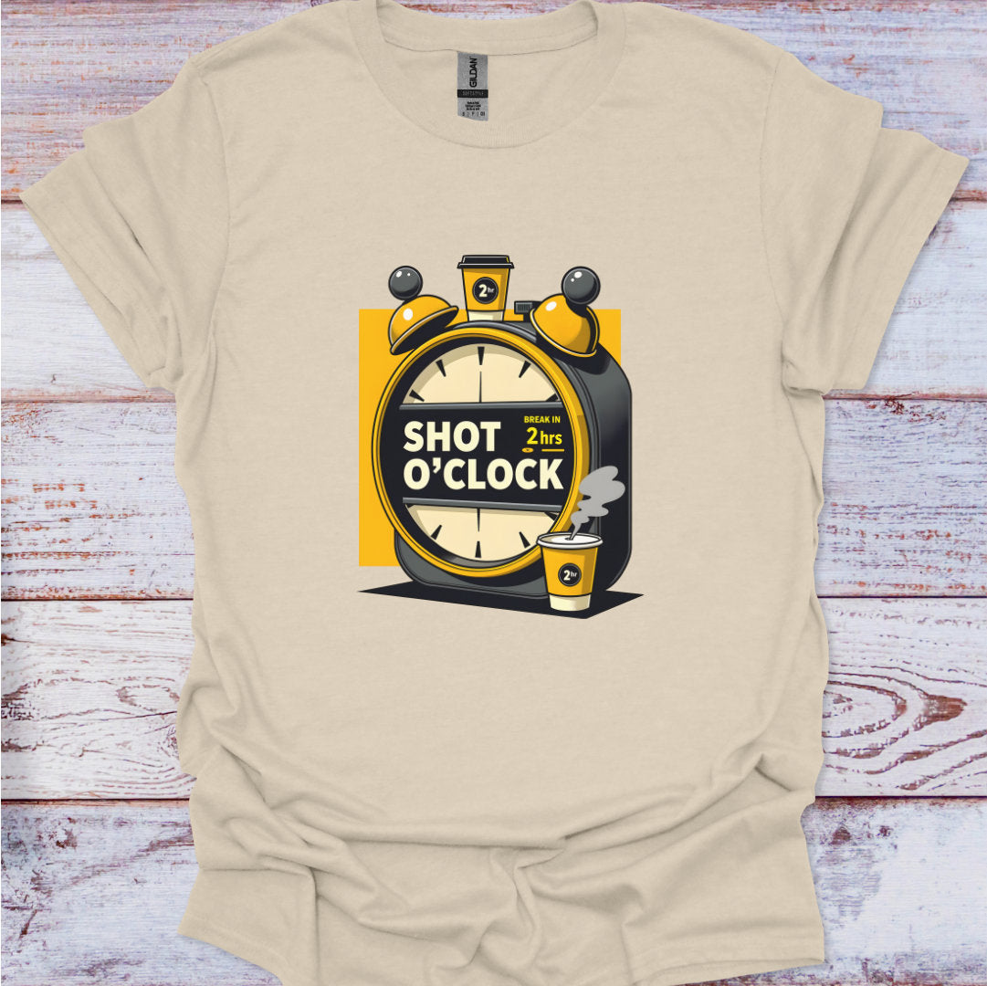 Beige t-shirt with 'Shot O'Clock' graphic design on a wooden surface