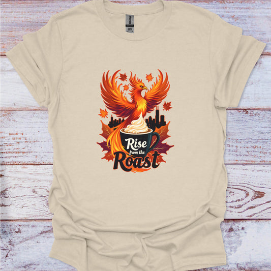 Beige t-shirt with a phoenix design and 'Rise from the Roast' text on a wooden surface