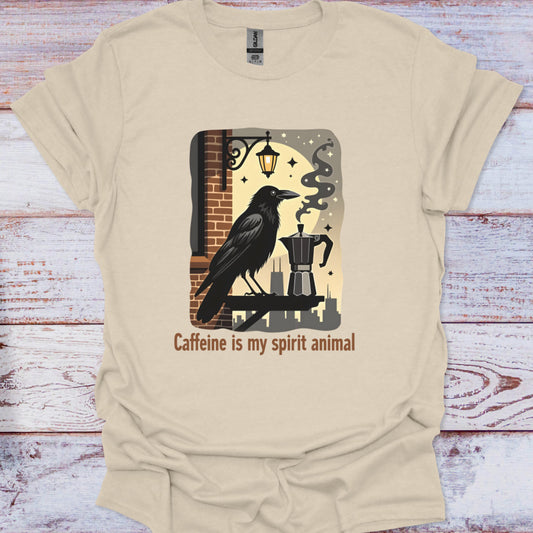 Beige t-shirt with a graphic of a crow and coffee pot on a wooden surface