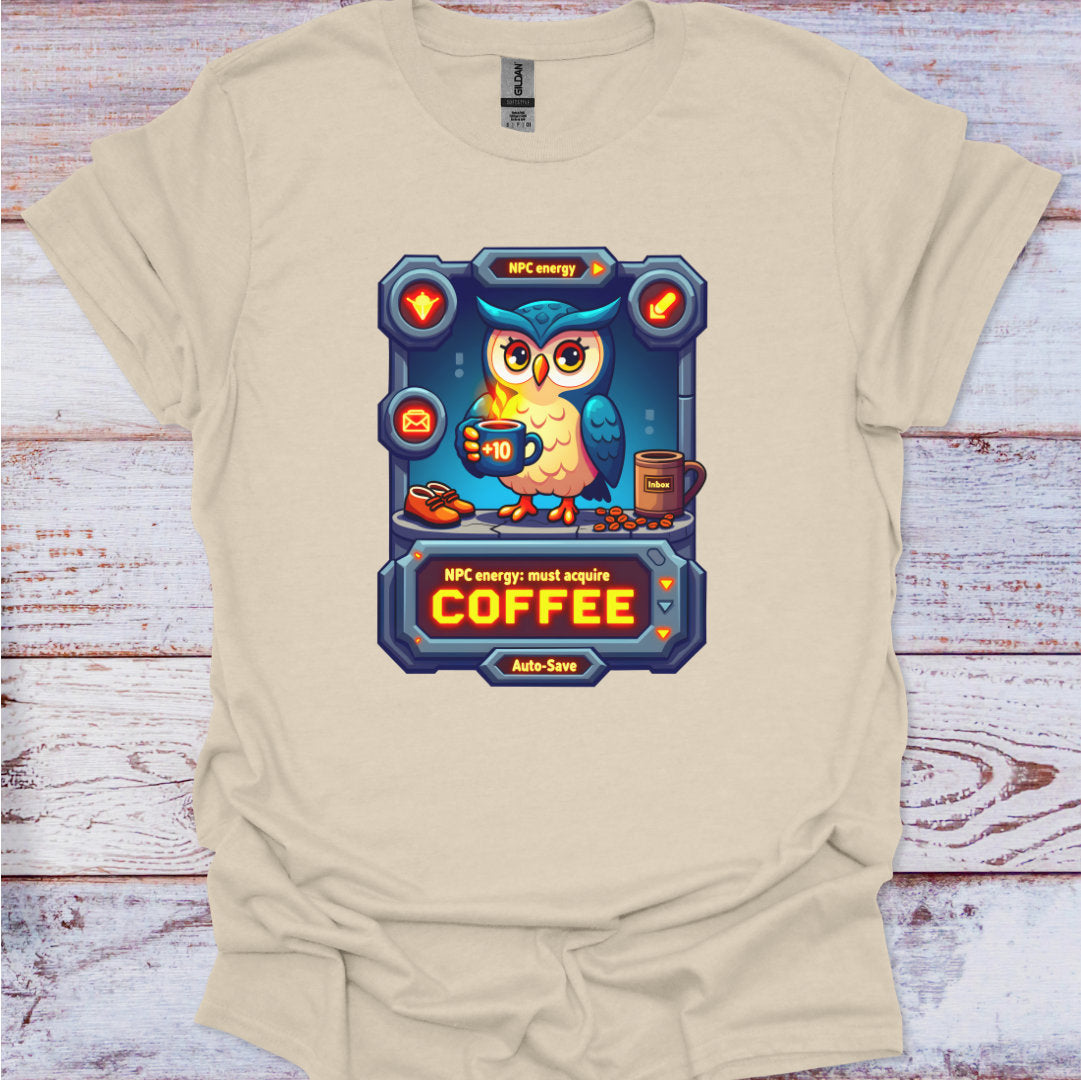 Beige t-shirt with an owl graphic and text on a wooden surface
