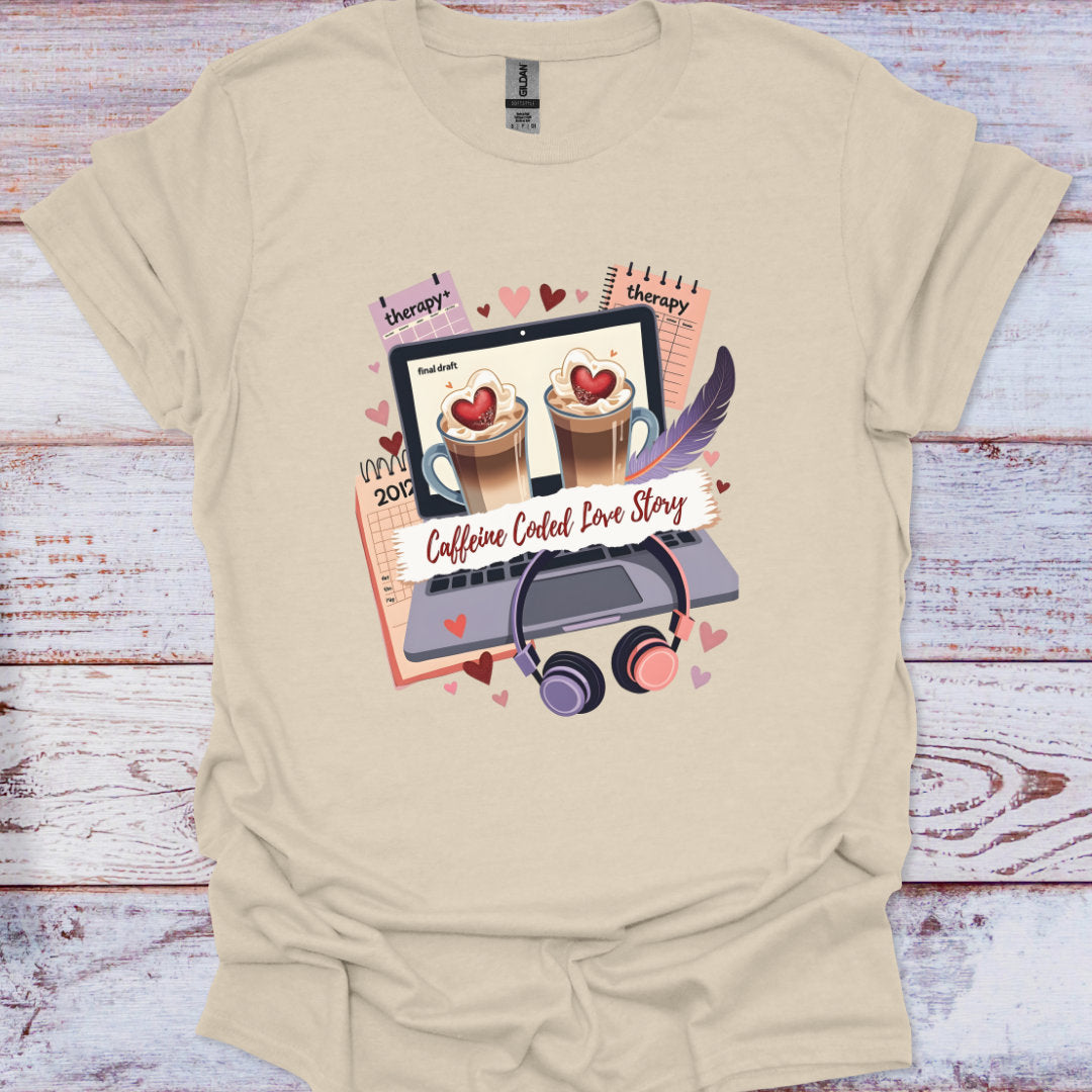 Beige t-shirt with a graphic design of coffee cups, laptop, and text on a wooden surface
