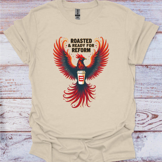 Beige t-shirt with a red and black phoenix design and text on a wooden surface