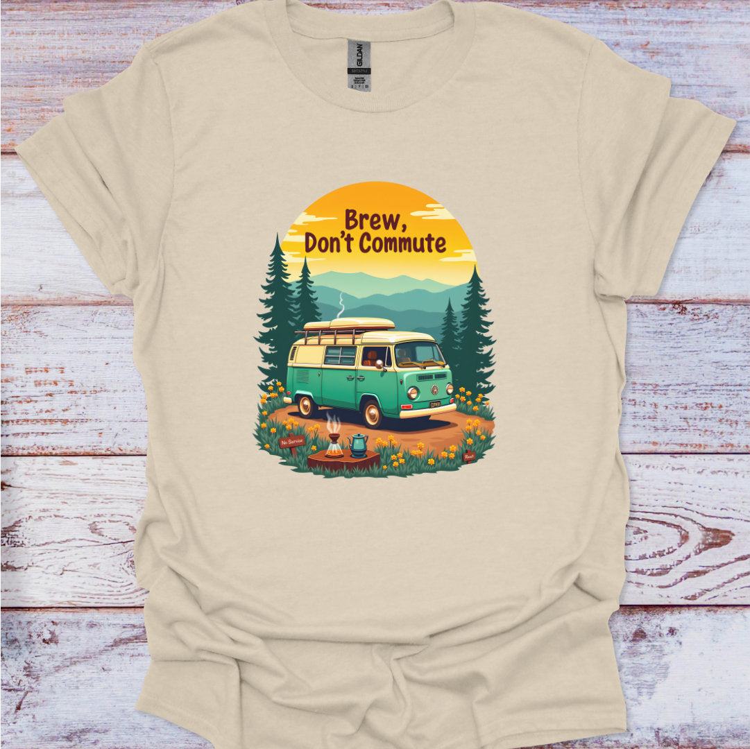 Beige t-shirt with a graphic of a van and trees, text 'Brew, Don't Commute', on a wooden surface.