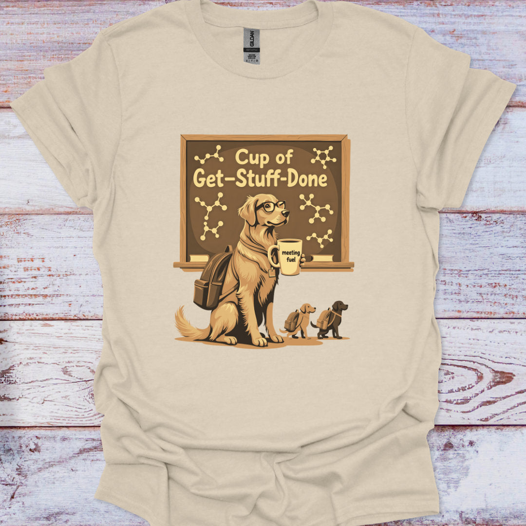 Beige t-shirt with a graphic of a dog and puppies under a sign reading 'Cup of Get-Stuff-Done' on a wooden surface.