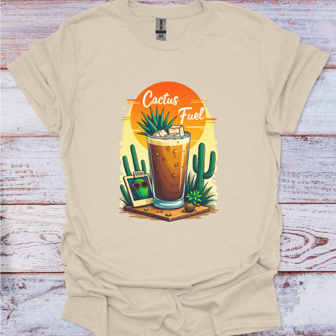 Beige t-shirt with a graphic of a glass of iced coffee with cacti and 'Cactus Fuel' text on a wooden surface.