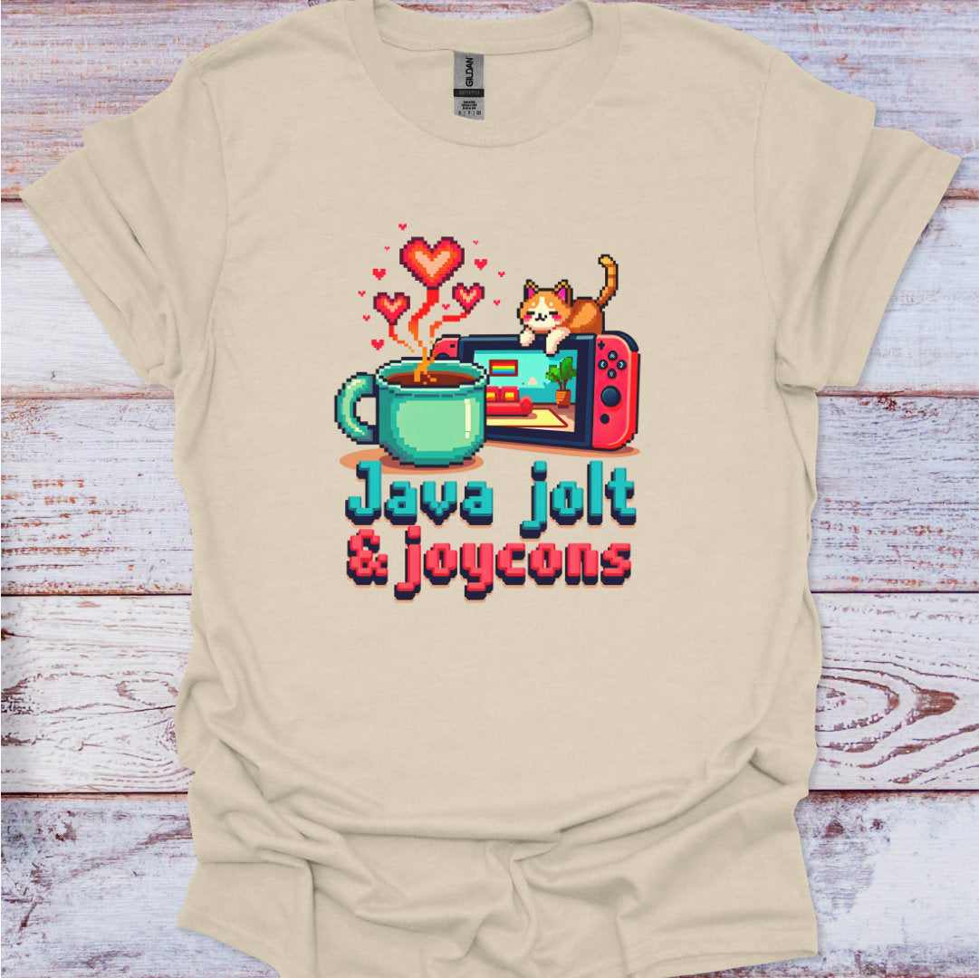 Beige t-shirt with a graphic design of a coffee mug, game console, and cat on a wooden surface.