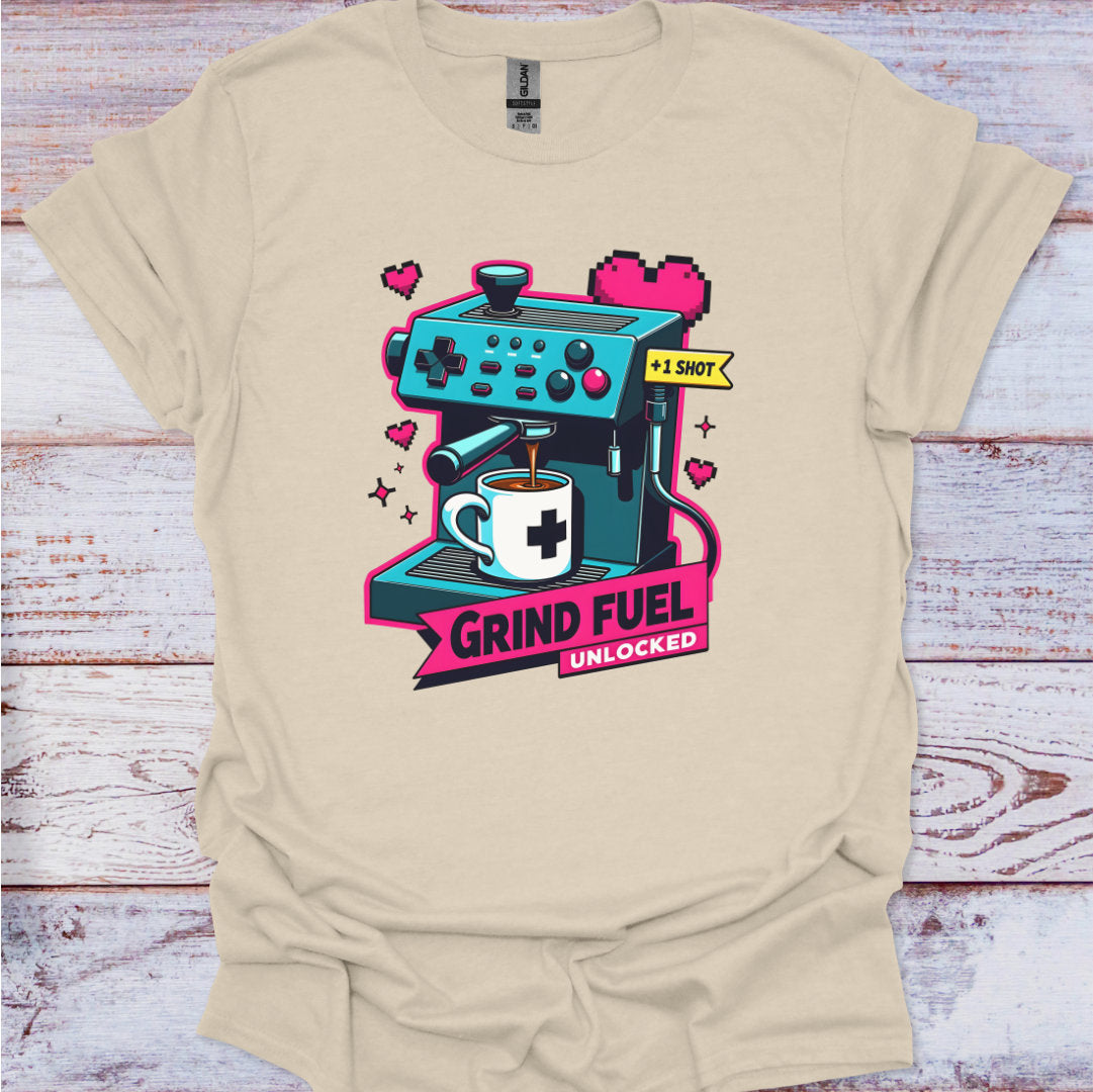 Beige t-shirt with a graphic design of an espresso machine and text on a wooden surface