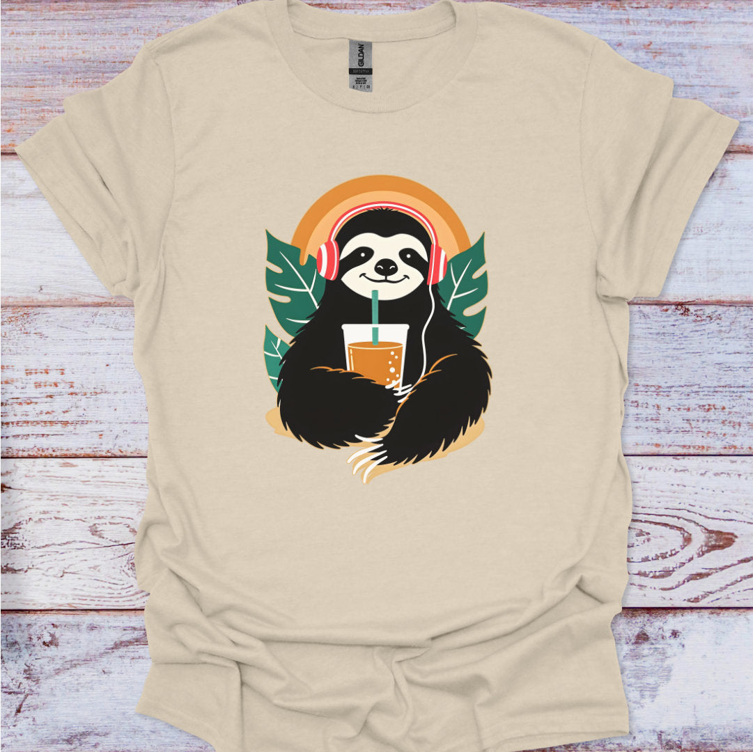 Beige t-shirt with a sloth holding a drink graphic on a wooden surface