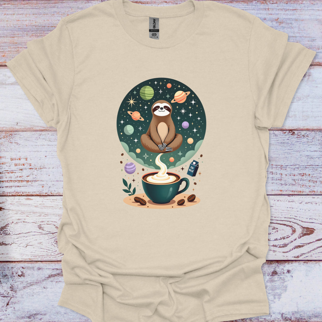 Beige t-shirt with a sloth and coffee cup graphic on a wooden surface