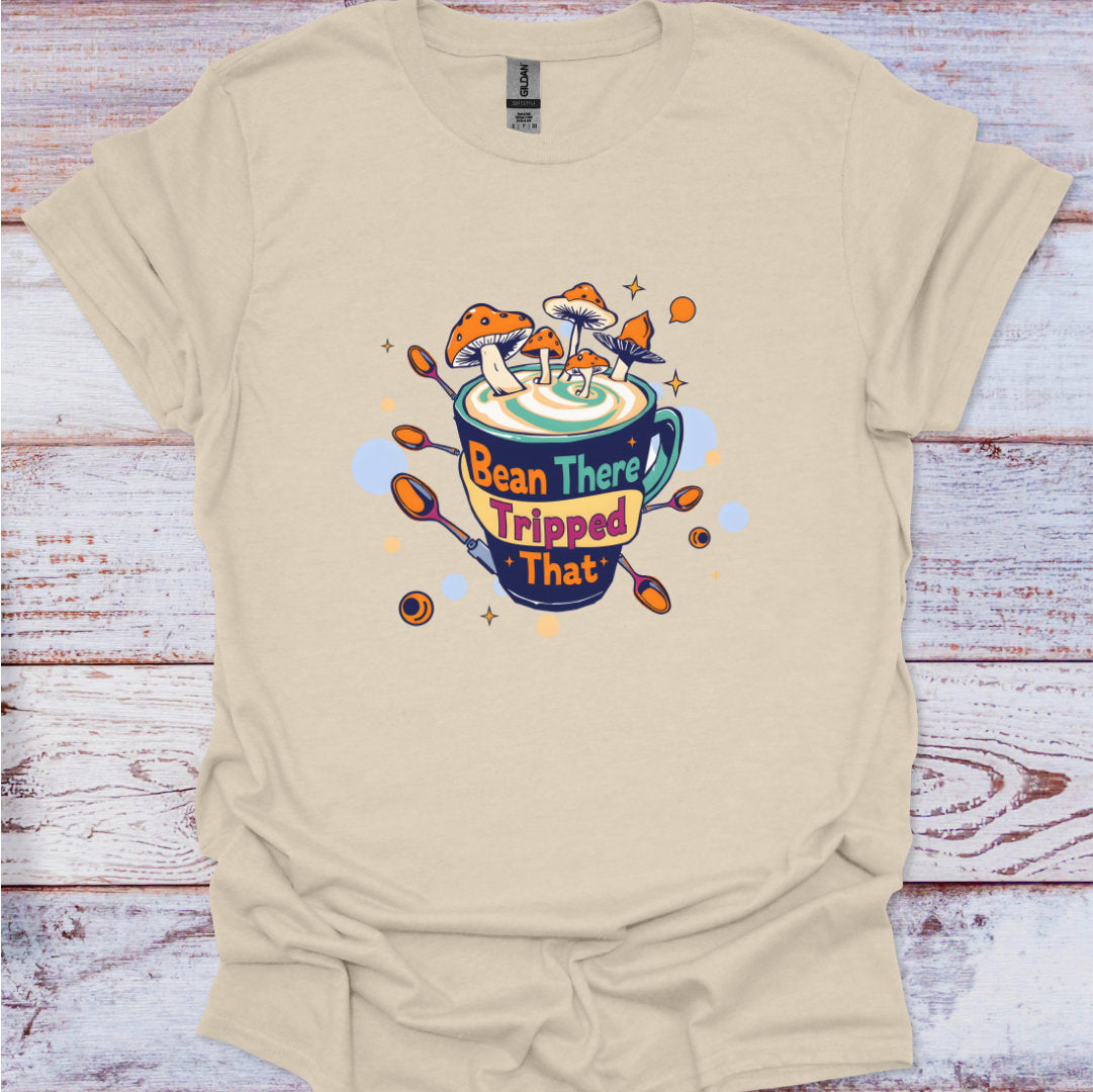 Beige t-shirt with a colorful graphic design on a wooden surface