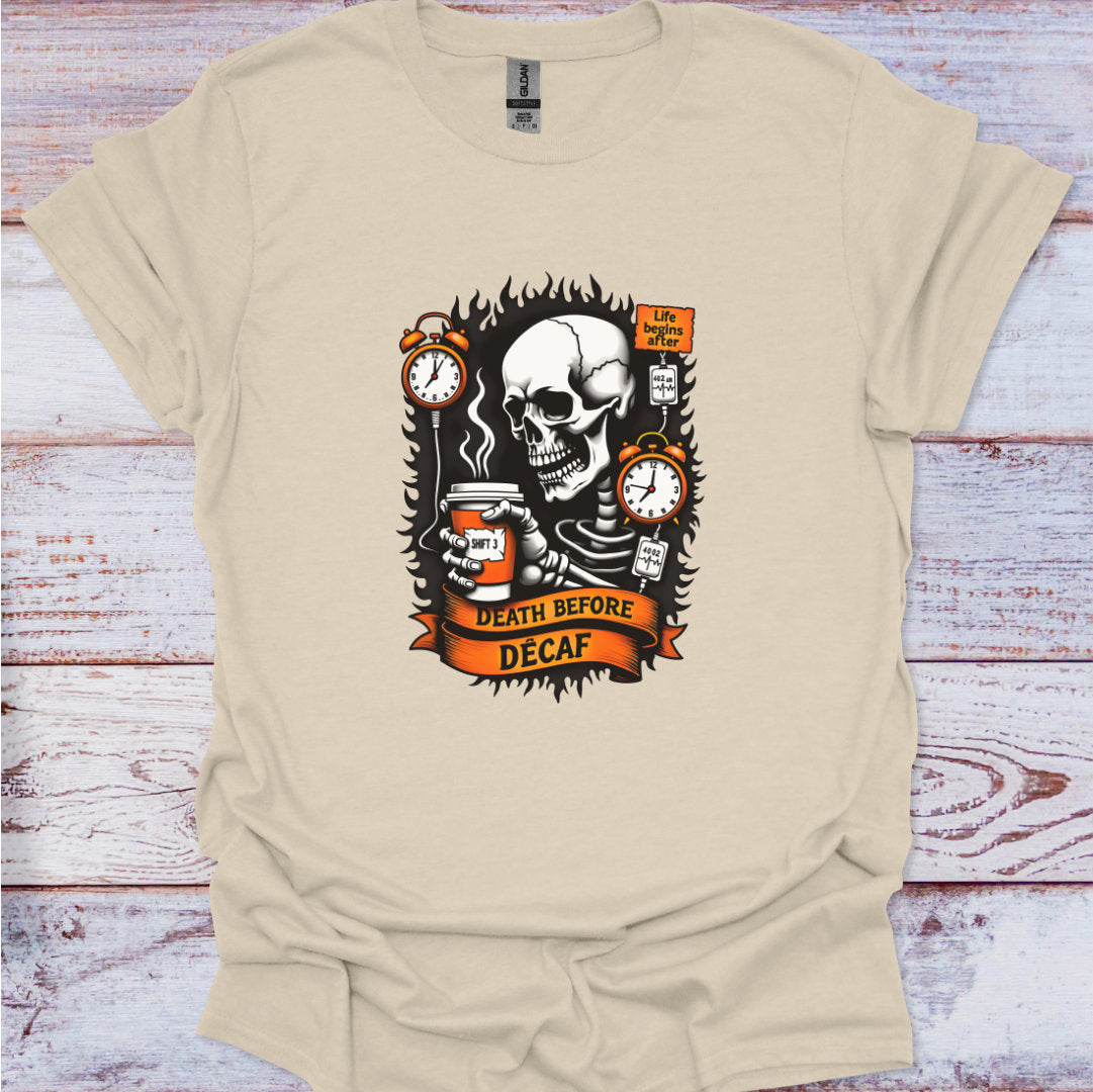 Beige t-shirt with a skull design and text 'Death Before Decaf' on a wooden surface.